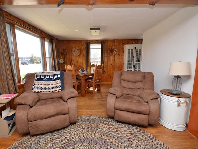 living area with wood walls and light wood-type flooring