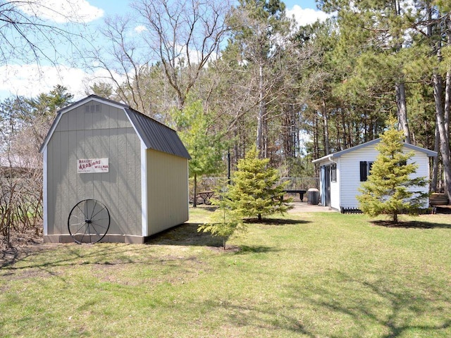 view of yard with a storage shed and an outbuilding