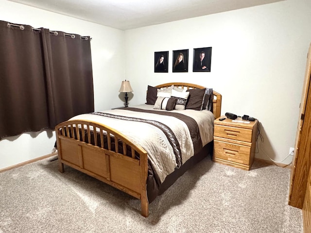 carpeted bedroom featuring baseboards