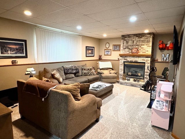 carpeted living area with recessed lighting, a paneled ceiling, and a fireplace