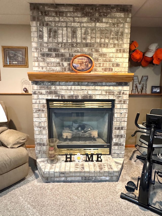 room details featuring baseboards, carpet, and a fireplace