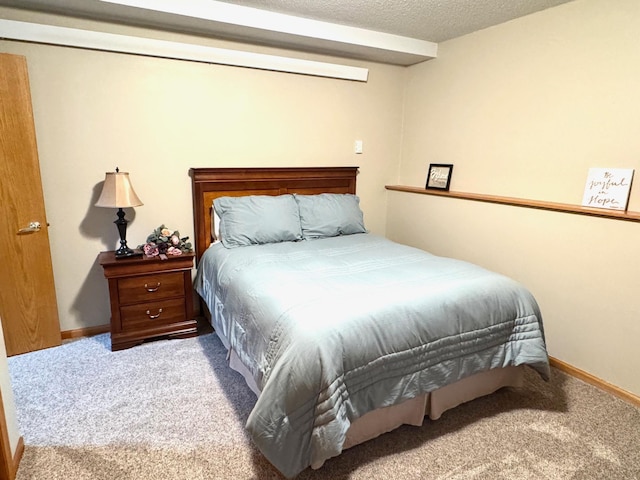 bedroom featuring carpet flooring, a textured ceiling, and baseboards