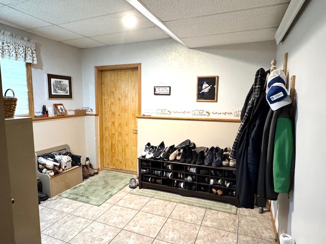 interior space with a paneled ceiling