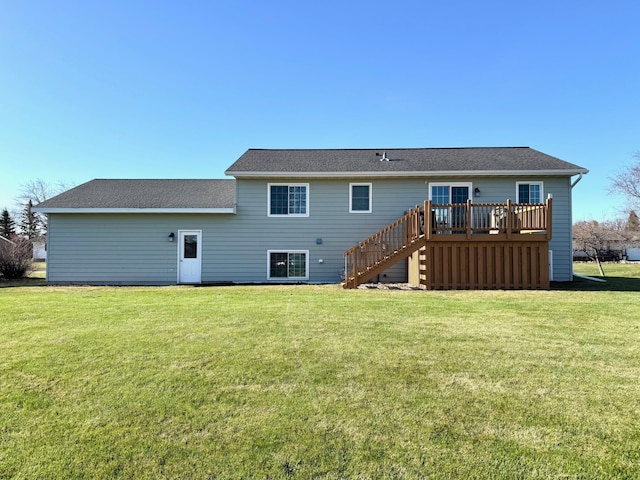 rear view of house with a wooden deck, a yard, and stairway