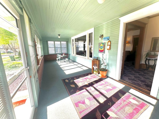 sunroom / solarium with carpet and wood ceiling
