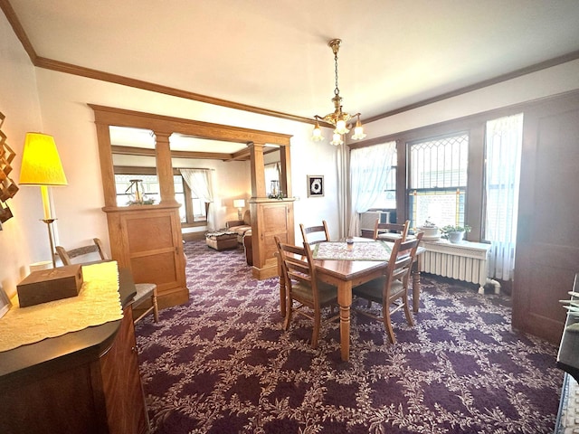 dining space with carpet flooring, radiator, ornamental molding, and a chandelier