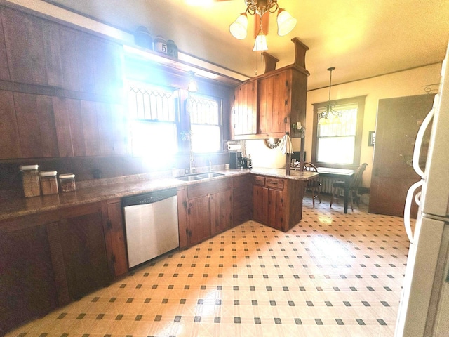kitchen with dishwasher, a sink, healthy amount of natural light, and pendant lighting