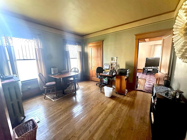 home office featuring wood finished floors and ornamental molding