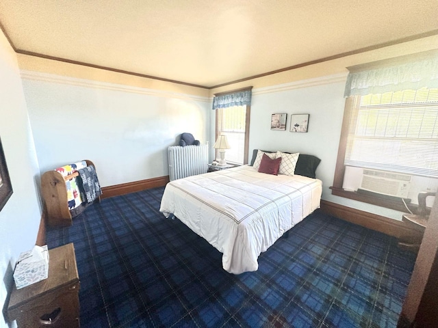 carpeted bedroom with ornamental molding, radiator heating unit, cooling unit, and baseboards