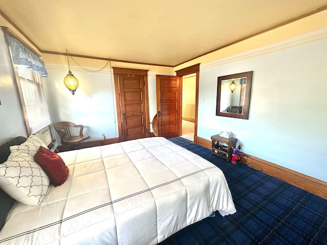 bedroom featuring crown molding, carpet, and baseboards