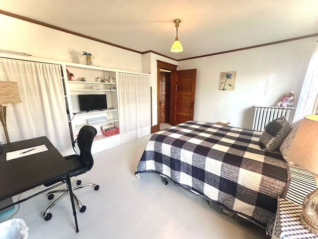 bedroom featuring ornamental molding and a desk