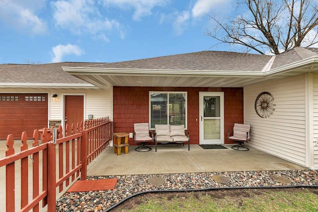doorway to property featuring an attached garage, fence, and roof with shingles