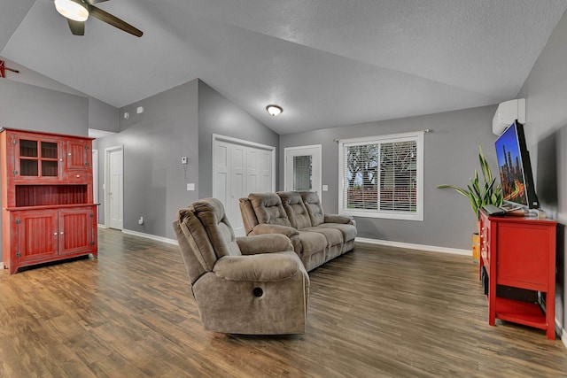 living area with baseboards, ceiling fan, and lofted ceiling