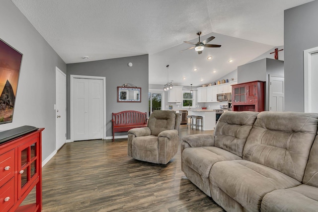 living area featuring a ceiling fan, a textured ceiling, baseboards, dark wood-style floors, and lofted ceiling