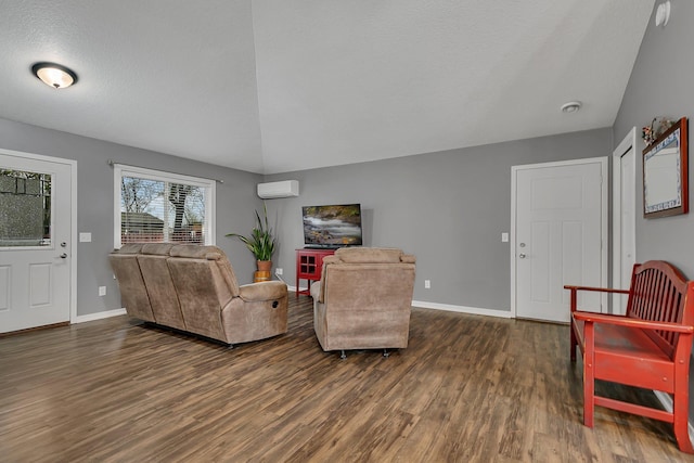 living room featuring an AC wall unit, baseboards, and wood finished floors