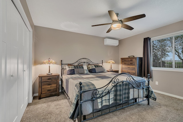bedroom featuring carpet flooring, baseboards, a wall unit AC, and a closet