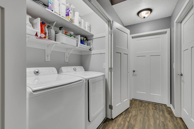 washroom with laundry area, a textured ceiling, dark wood-style floors, and washing machine and clothes dryer