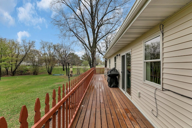 wooden deck featuring a yard