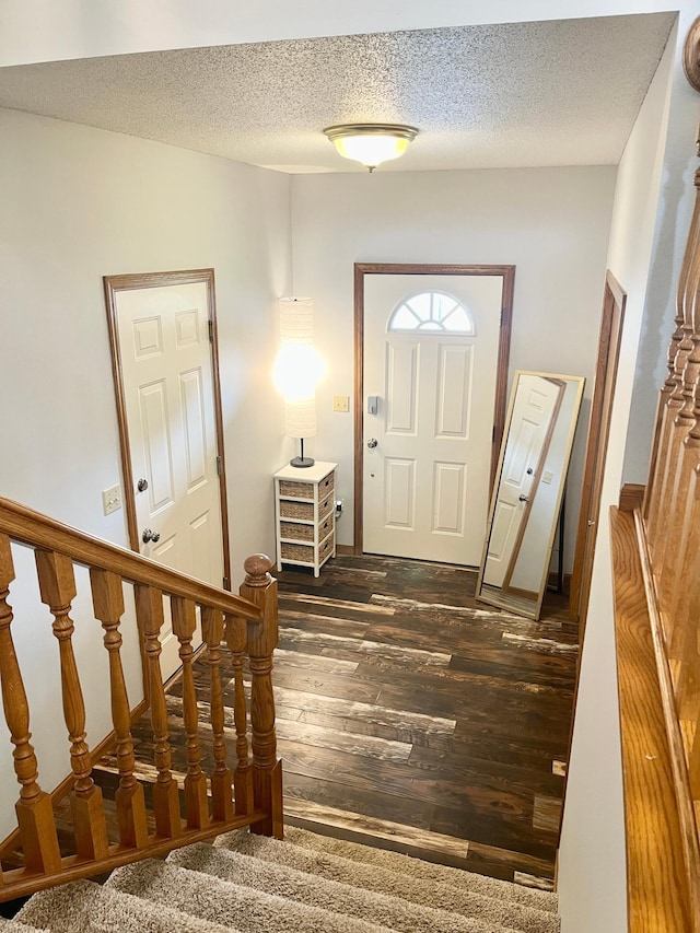 816 3rd St S, Sartell, MN 56377 - entryway featuring dark wood-style floors, stairs, and a textured ceiling