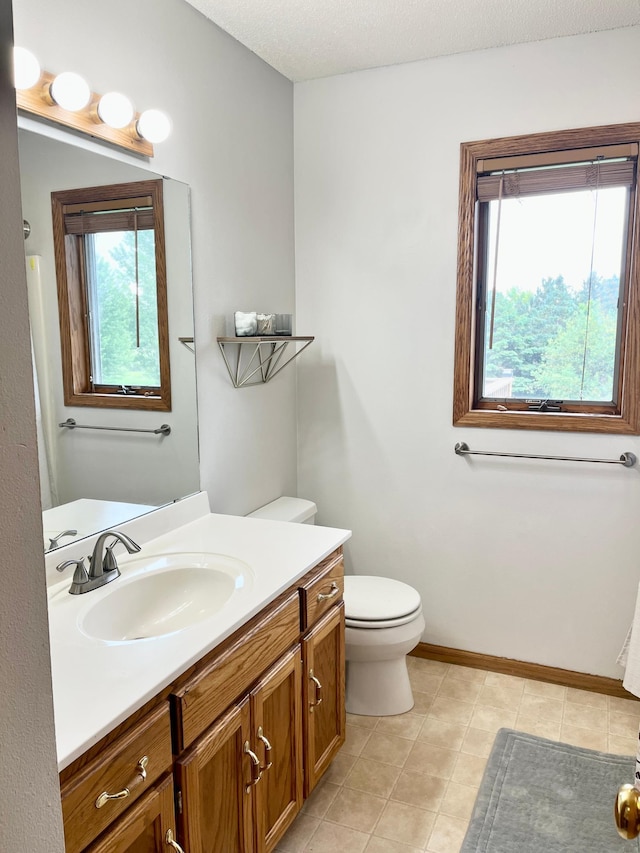 816 3rd St S, Sartell, MN 56377 - bathroom with toilet, vanity, and baseboards