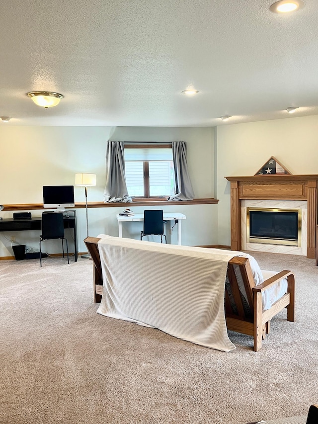 816 3rd St S, Sartell, MN 56377 - living room featuring carpet floors, a desk, a textured ceiling, and a glass covered fireplace