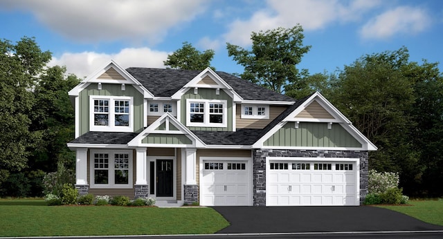 craftsman inspired home featuring stone siding, board and batten siding, a front lawn, and aphalt driveway