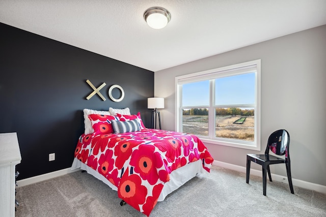 carpeted bedroom with baseboards