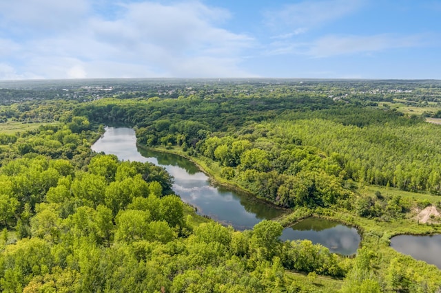 drone / aerial view featuring a water view and a wooded view