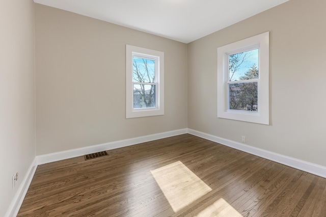 empty room with wood finished floors and baseboards