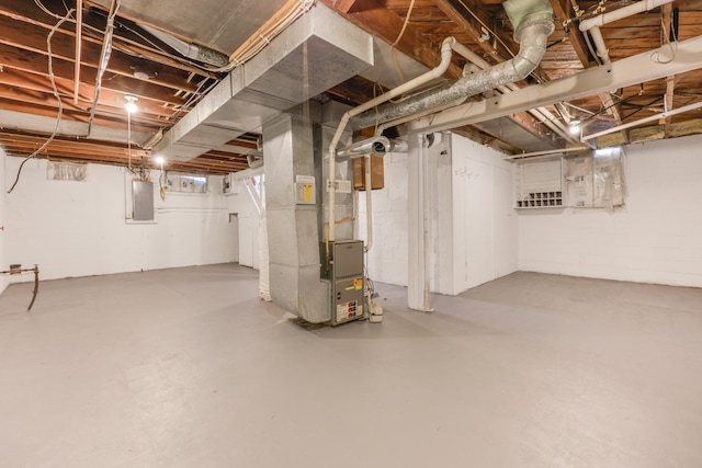 unfinished basement with heating unit and electric panel