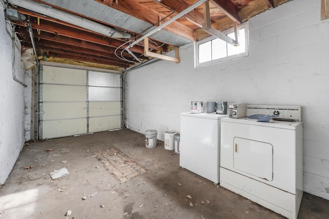 garage with washer and dryer and concrete block wall