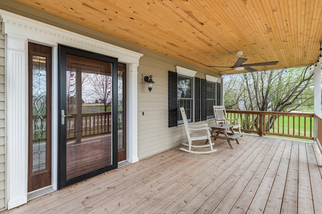 wooden deck featuring a porch and a ceiling fan