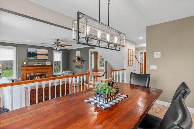 dining area with baseboards, a ceiling fan, a brick fireplace, and recessed lighting