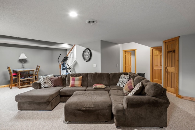 carpeted living room featuring visible vents, a textured ceiling, and baseboards
