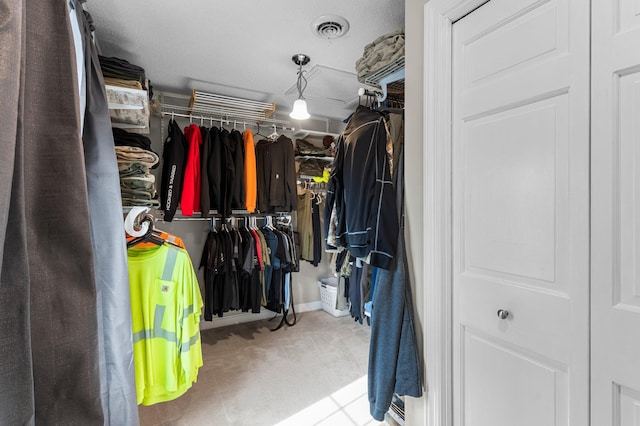 walk in closet featuring visible vents and carpet