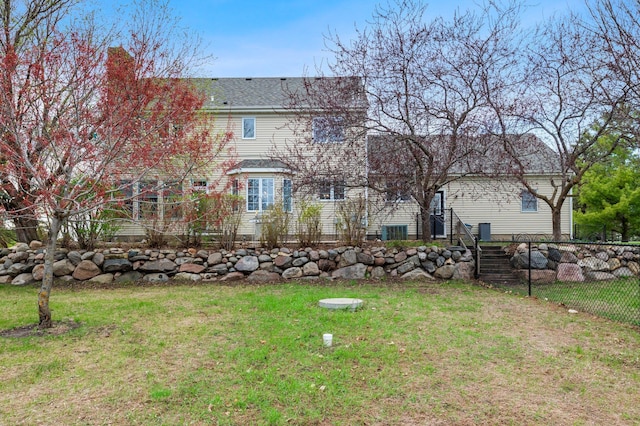 view of yard with fence and stairway