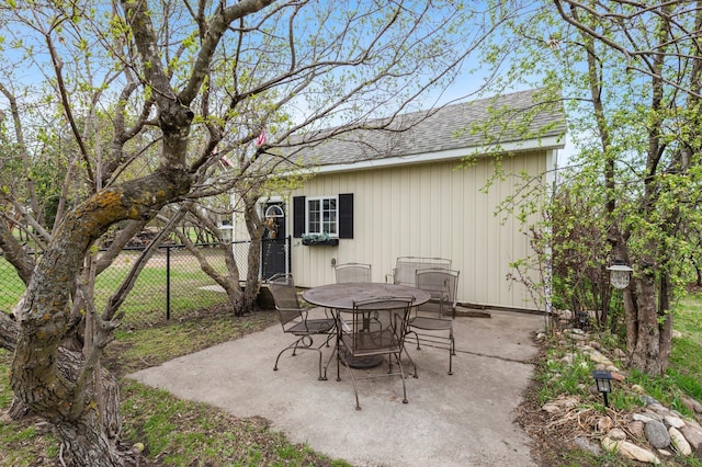 view of patio with outdoor dining area and fence