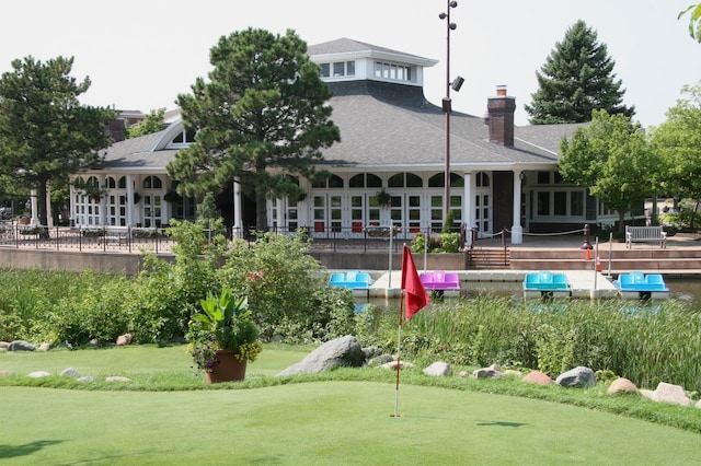7200 York Ave S Unit 304, Edina, MN 55435 - back of property featuring a putting area, a chimney, and roof with shingles