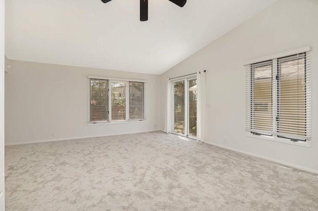 carpeted spare room featuring a ceiling fan, baseboards, visible vents, and lofted ceiling