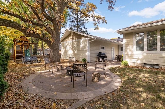 view of patio with a playground and area for grilling