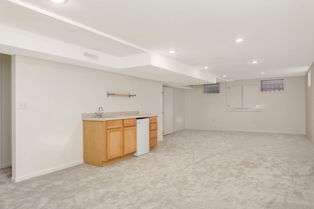 interior space with light carpet, baseboards, recessed lighting, a sink, and wet bar