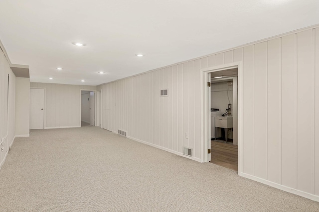 finished basement featuring visible vents, recessed lighting, and light carpet