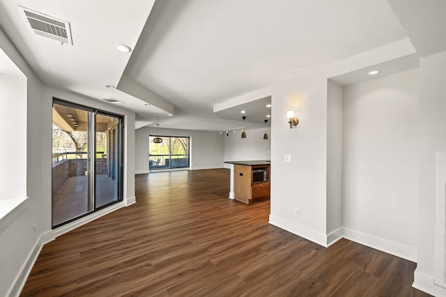 empty room with visible vents, recessed lighting, dark wood finished floors, and baseboards