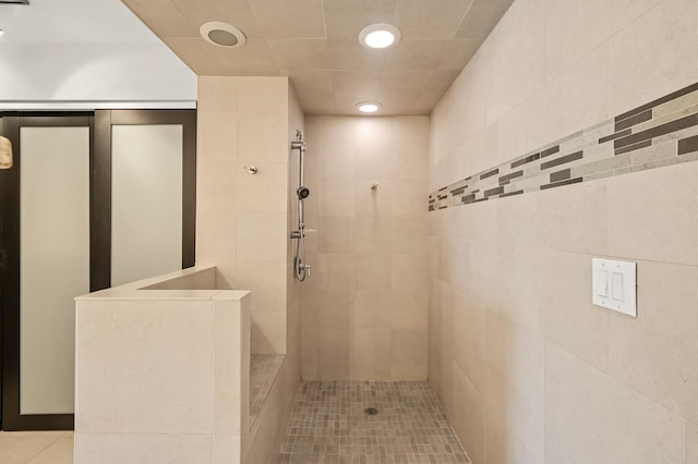 full bath with tile patterned floors, a tile shower, and recessed lighting