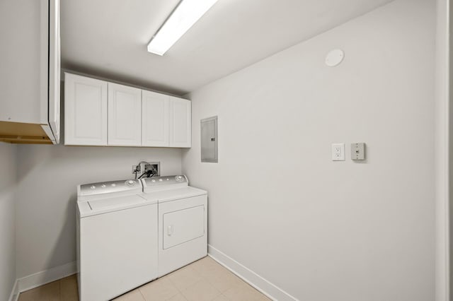 washroom featuring electric panel, washing machine and dryer, cabinet space, light tile patterned floors, and baseboards