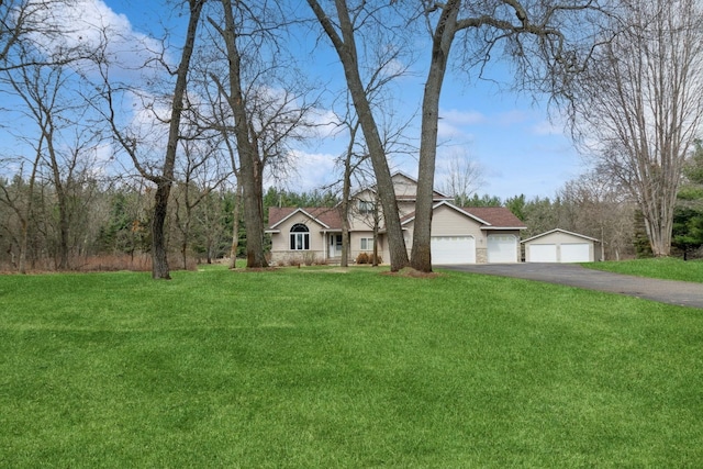 14580 30th St, Clear Lake, MN 55319 - view of front of house featuring asphalt driveway, a front yard, and an attached garage