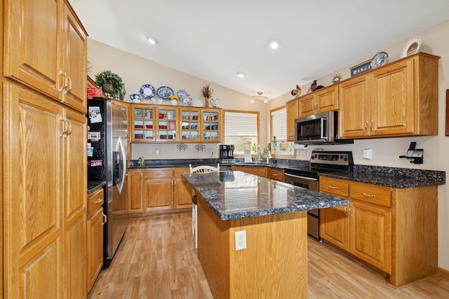 14580 30th St, Clear Lake, MN 55319 - kitchen featuring stainless steel appliances, lofted ceiling, a center island, light wood finished floors, and dark stone countertops