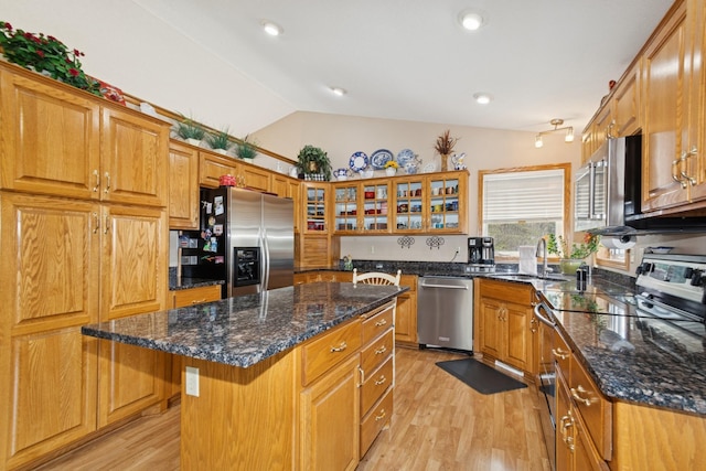 14580 30th St, Clear Lake, MN 55319 - kitchen with appliances with stainless steel finishes, light wood-type flooring, a kitchen island, vaulted ceiling, and brown cabinets