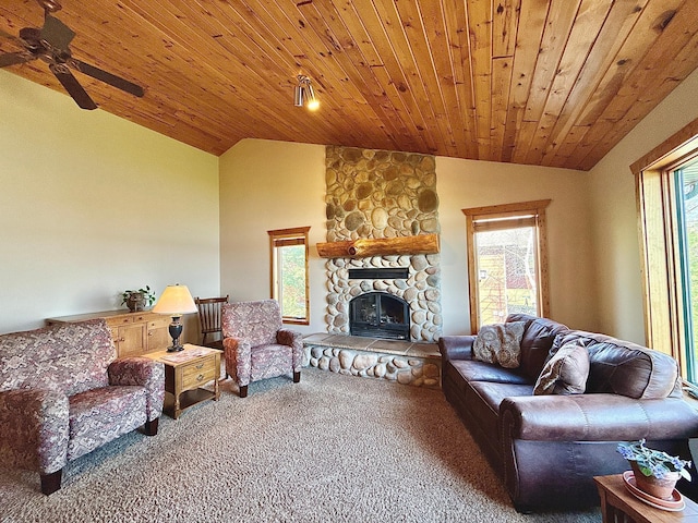 carpeted living area with lofted ceiling, ceiling fan, a stone fireplace, and wood ceiling