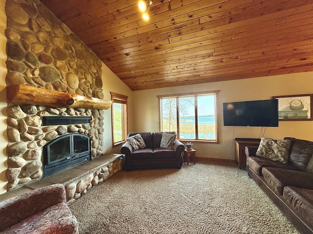 living area with carpet, lofted ceiling, wood ceiling, baseboards, and a stone fireplace